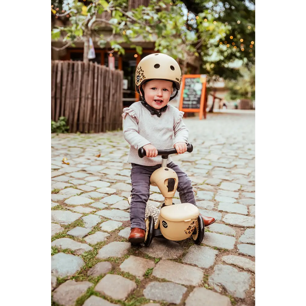 A girl on the Scoot & Ride Highway Kick 1 Lifestyle Leopard Scooter