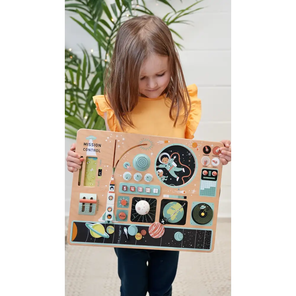 Girl holding Tenderleaf Toys Space Station Busy Board